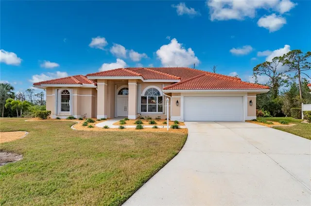 a front view of a house with yard and outdoor seating