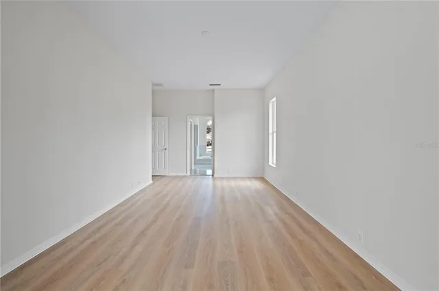 a view of an empty room and wooden floor