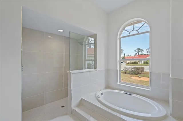 a bathroom with a bathtub and a shower