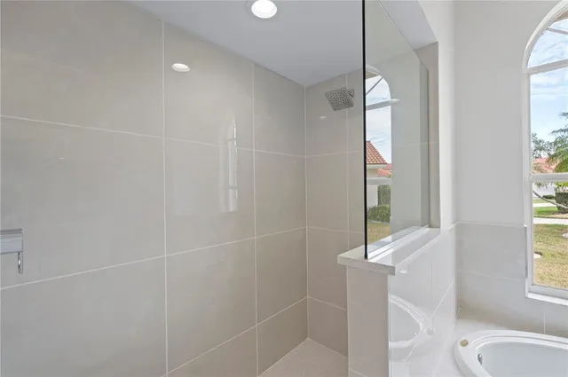 a bathroom with a shower and a window