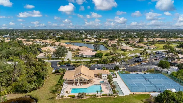 an aerial view of residential houses with outdoor space and trees