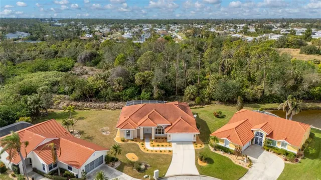 an aerial view of a house with swimming pool and outdoor seating