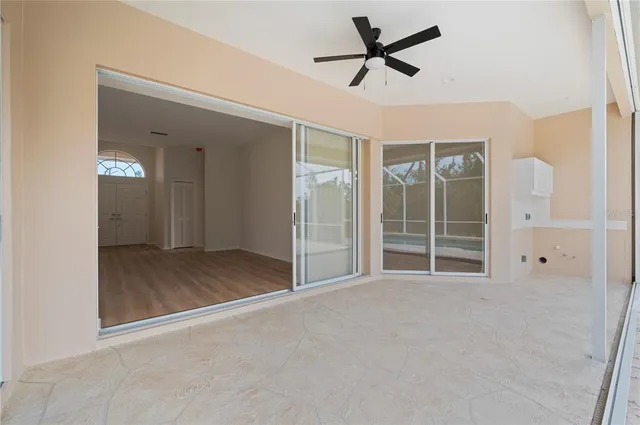 a view of a livingroom with a ceiling fan and window