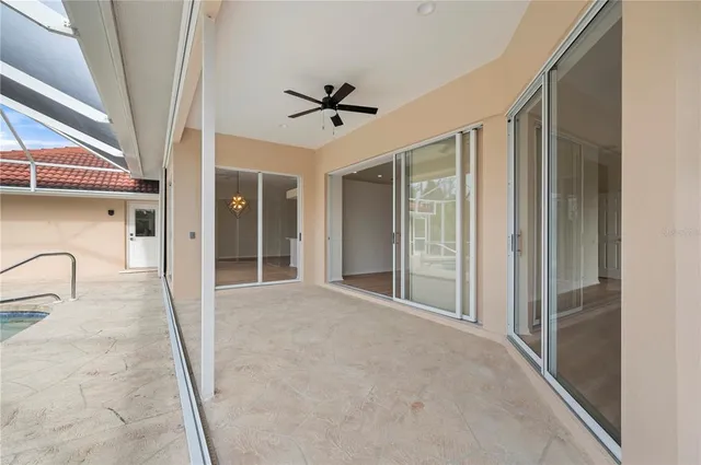 a view of a livingroom with a ceiling fan & window