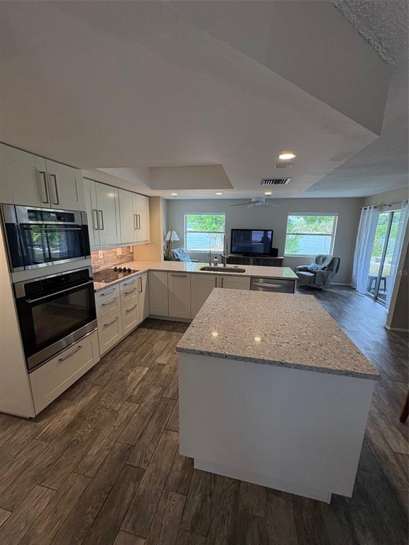 947 Shasta Road Venice, FL 34293 - Photo 16 of 52 a kitchen with stainless steel appliances granite countertop a stove a sink and a refrigerator