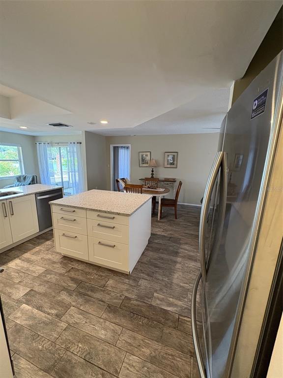 947 Shasta Road Venice, FL 34293 - Photo 20 of 52 a large room with a large window and white cabinets