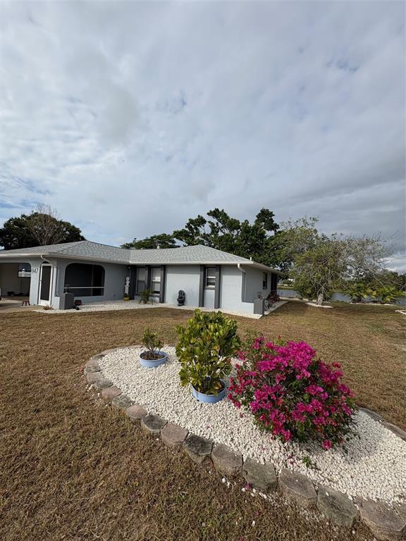 947 Shasta Road Venice, FL 34293 - Photo 2 of 52 a front view of a house with a yard