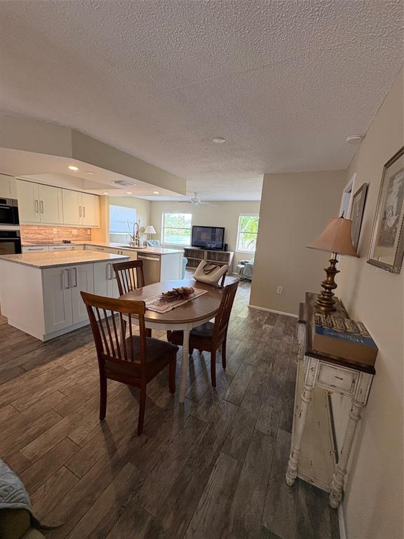 947 Shasta Road Venice, FL 34293 - Photo 24 of 52 a view of a dining room with furniture and wooden floor