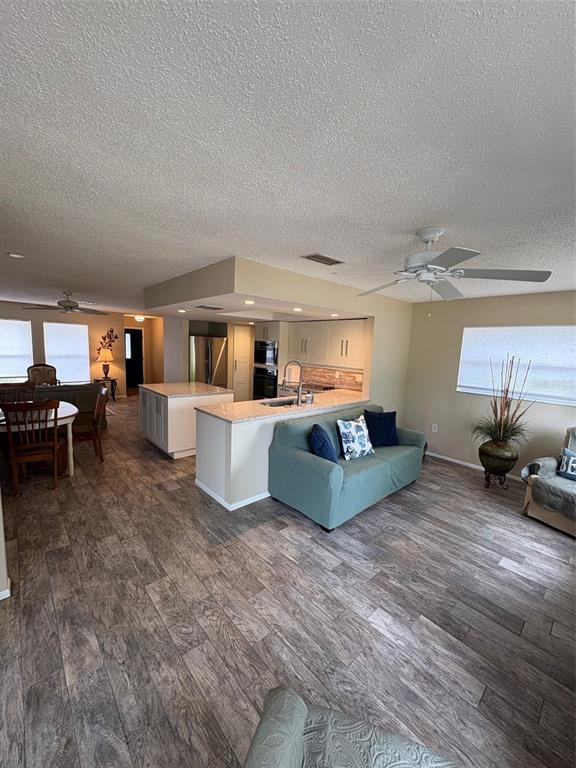 947 Shasta Road Venice, FL 34293 - Photo 31 of 52 a living room with furniture and a wooden floor