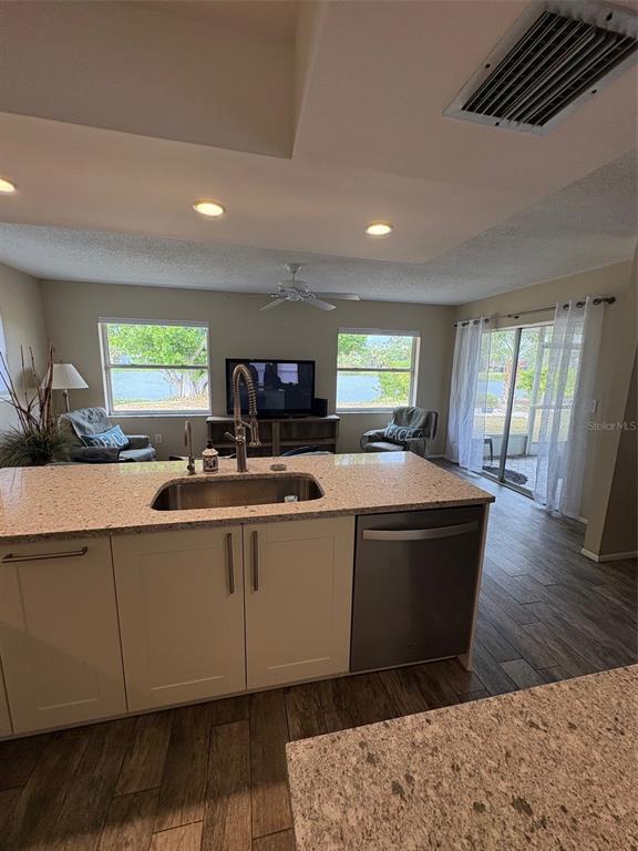 947 Shasta Road Venice, FL 34293 - Photo 34 of 52 a living room with stainless steel appliances granite countertop furniture a fireplace and a large window