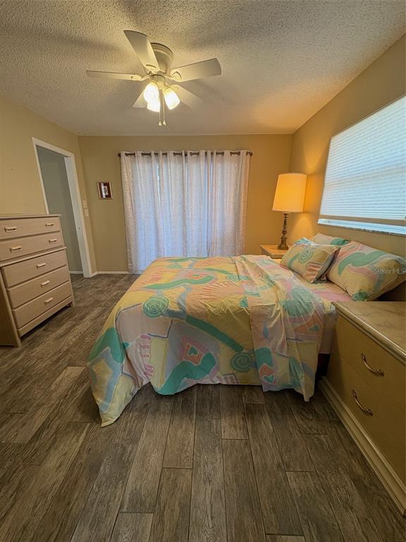 947 Shasta Road Venice, FL 34293 - Photo 35 of 52 a bedroom with a bed and wooden floor