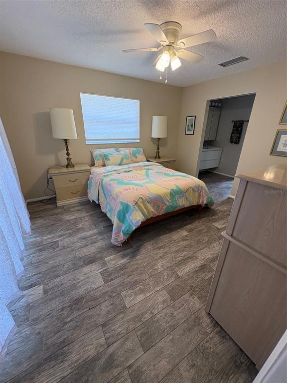 947 Shasta Road Venice, FL 34293 - Photo 36 of 52 a bedroom with a bed and a chandelier