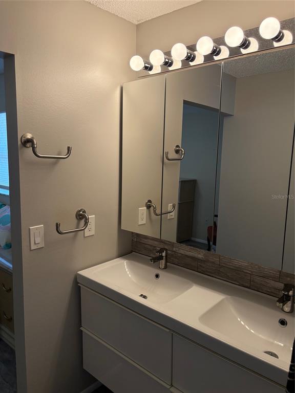 947 Shasta Road Venice, FL 34293 - Photo 38 of 52 a bathroom with a sink vanity and mirror