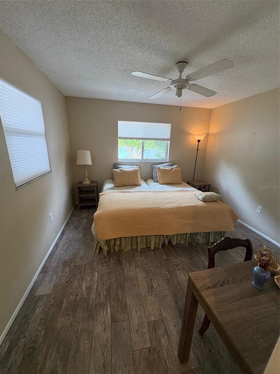 947 Shasta Road Venice, FL 34293 - Photo 42 of 52 a bedroom with a bed and wooden floor