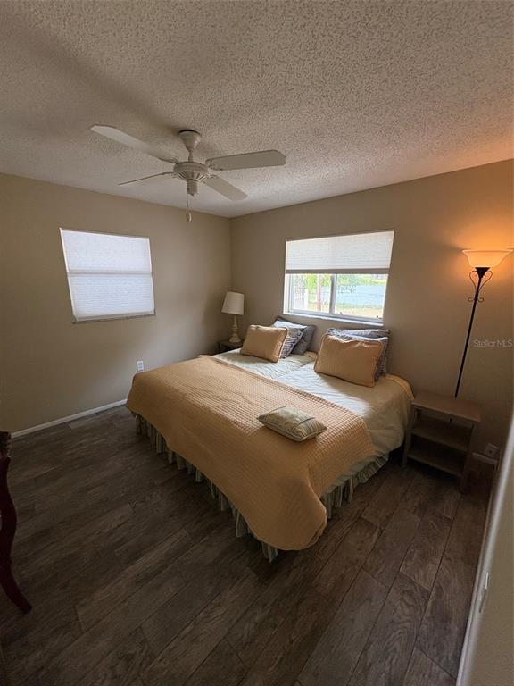 947 Shasta Road Venice, FL 34293 - Photo 44 of 52 a bedroom with a bed and wooden floor