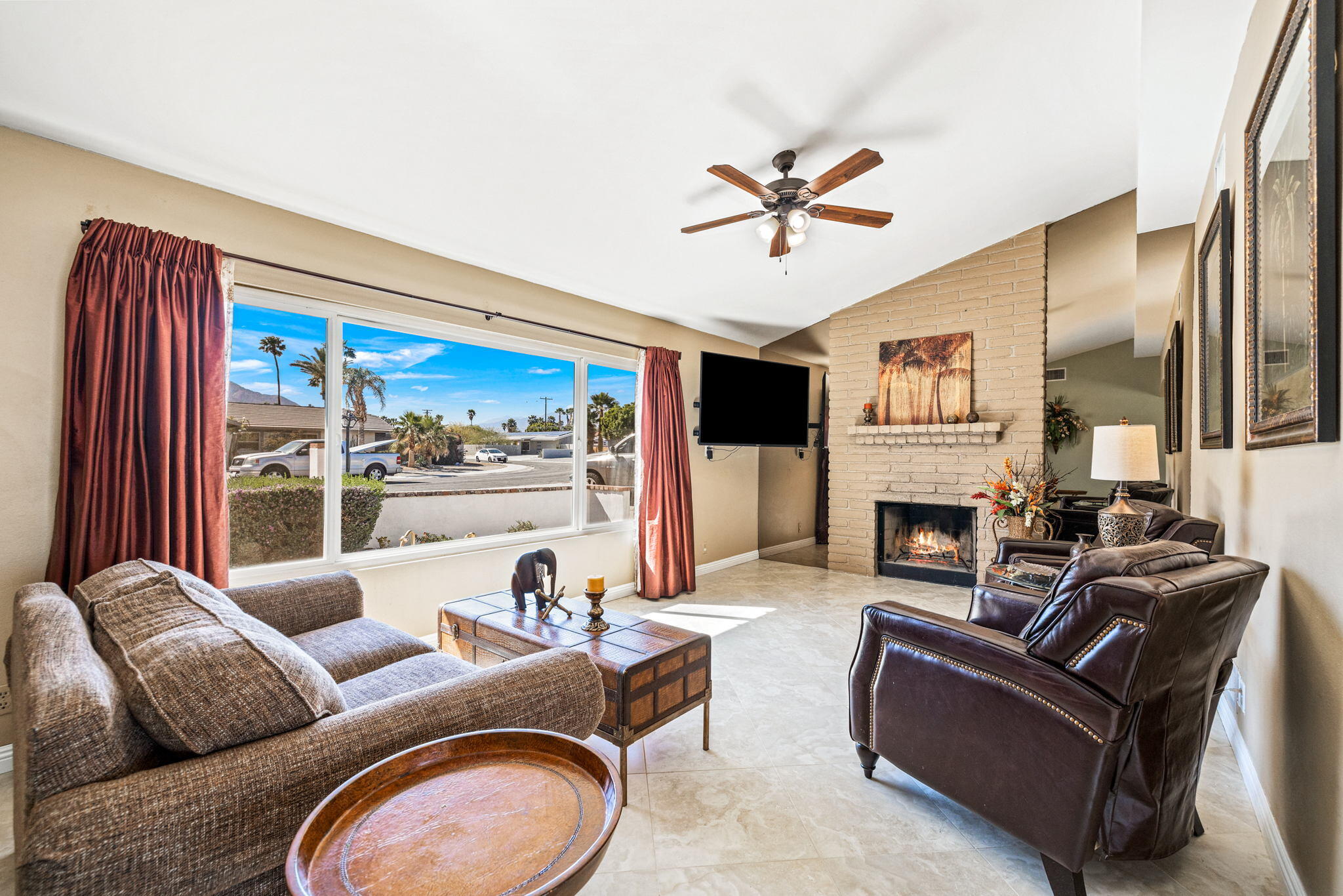2290 North Victoria Road Palm Springs, CA 92262 - Photo 11 of 42 a living room with furniture a fireplace and a large window