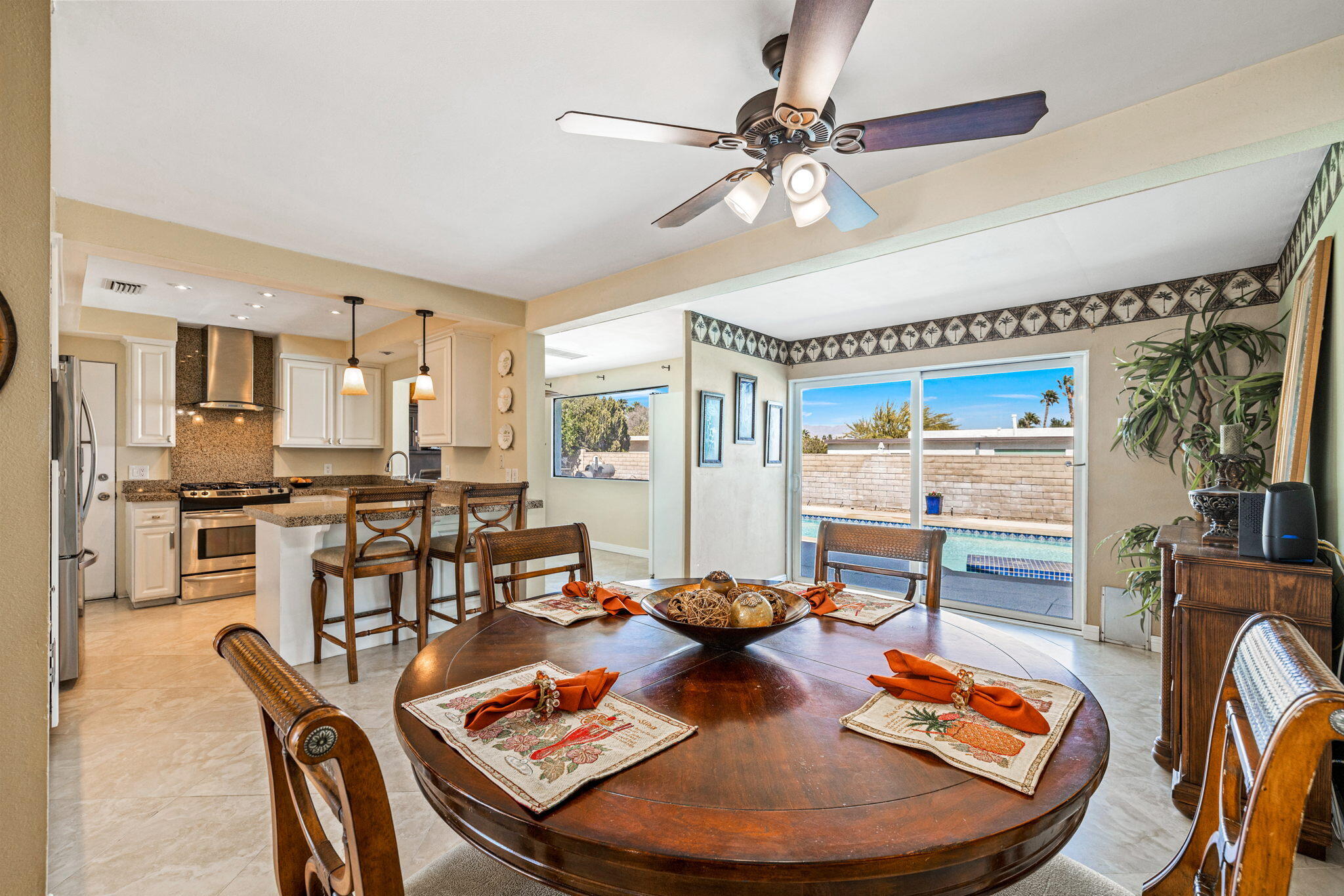 2290 North Victoria Road Palm Springs, CA 92262 - Photo 14 of 42 a dining room with furniture a kitchen view and a chandelier