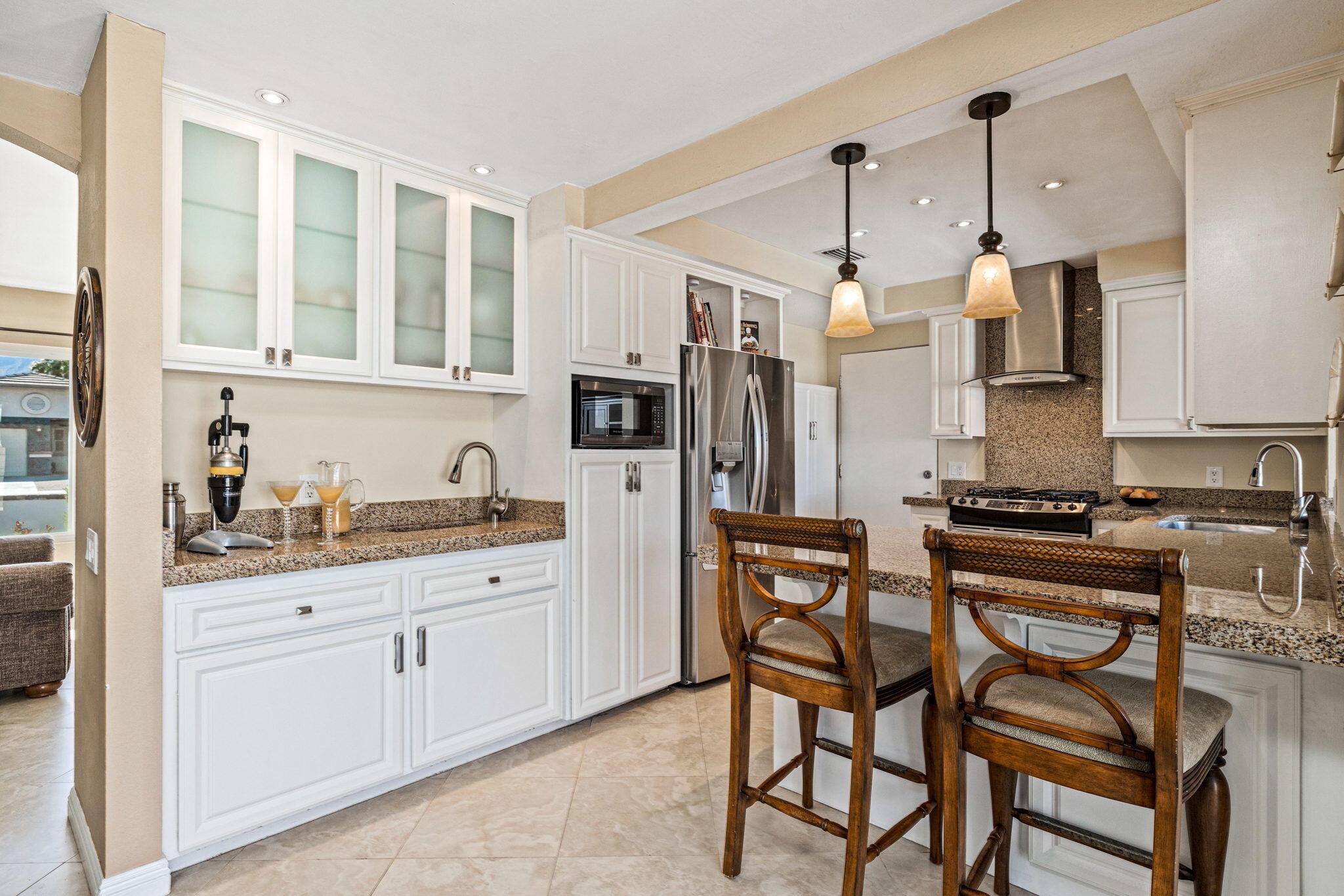 2290 North Victoria Road Palm Springs, CA 92262 - Photo 16 of 42 a kitchen with stainless steel appliances granite countertop a stove a sink dishwasher and a refrigerator with wooden cabinets