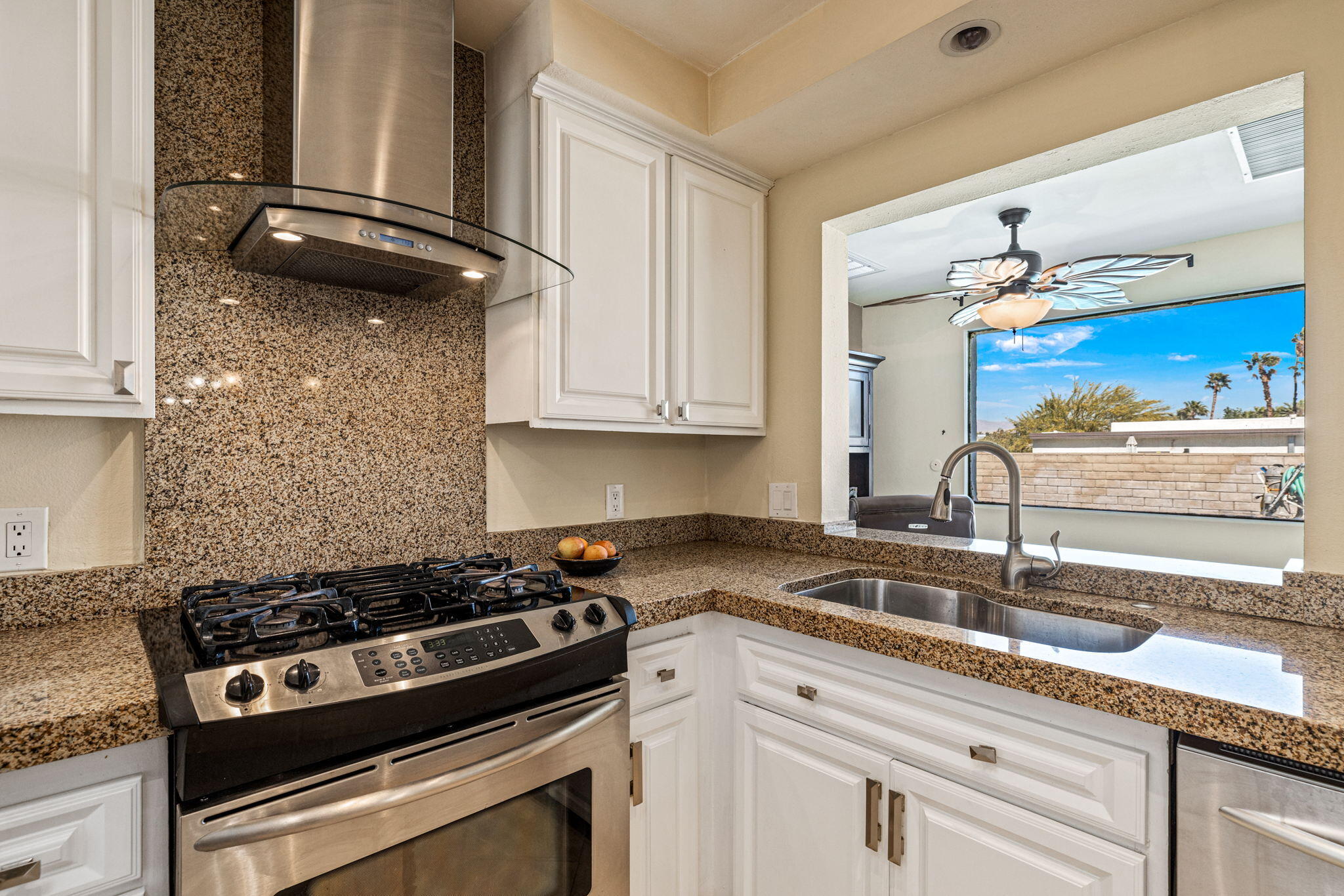 2290 North Victoria Road Palm Springs, CA 92262 - Photo 17 of 42 a kitchen with granite countertop a sink stainless steel appliances and cabinets
