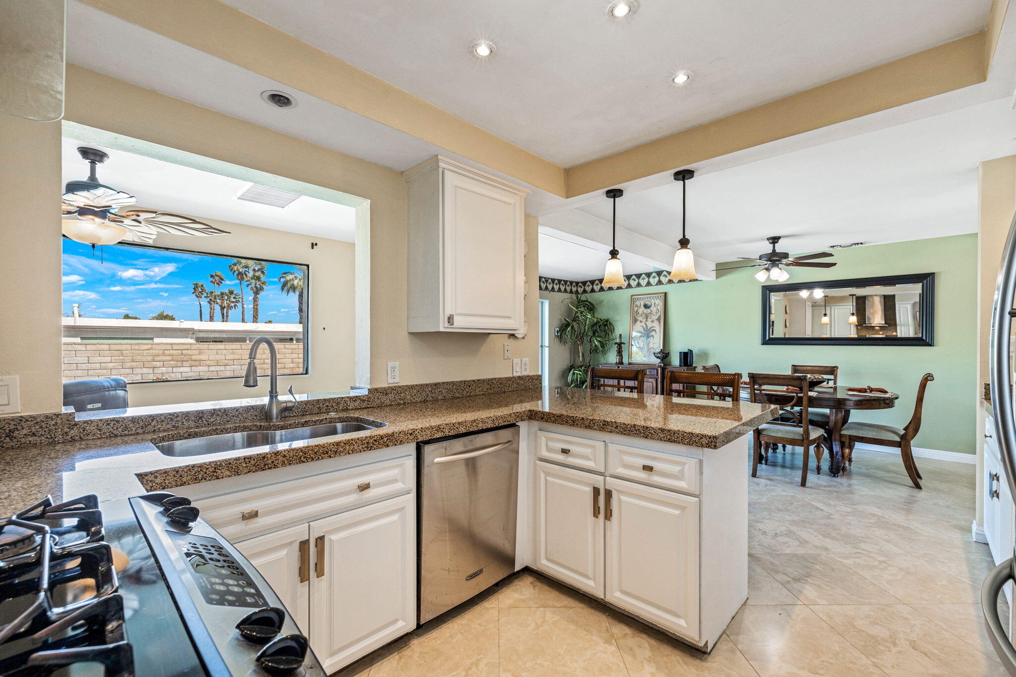 2290 North Victoria Road Palm Springs, CA 92262 - Photo 18 of 42 a kitchen with a sink stove and cabinets