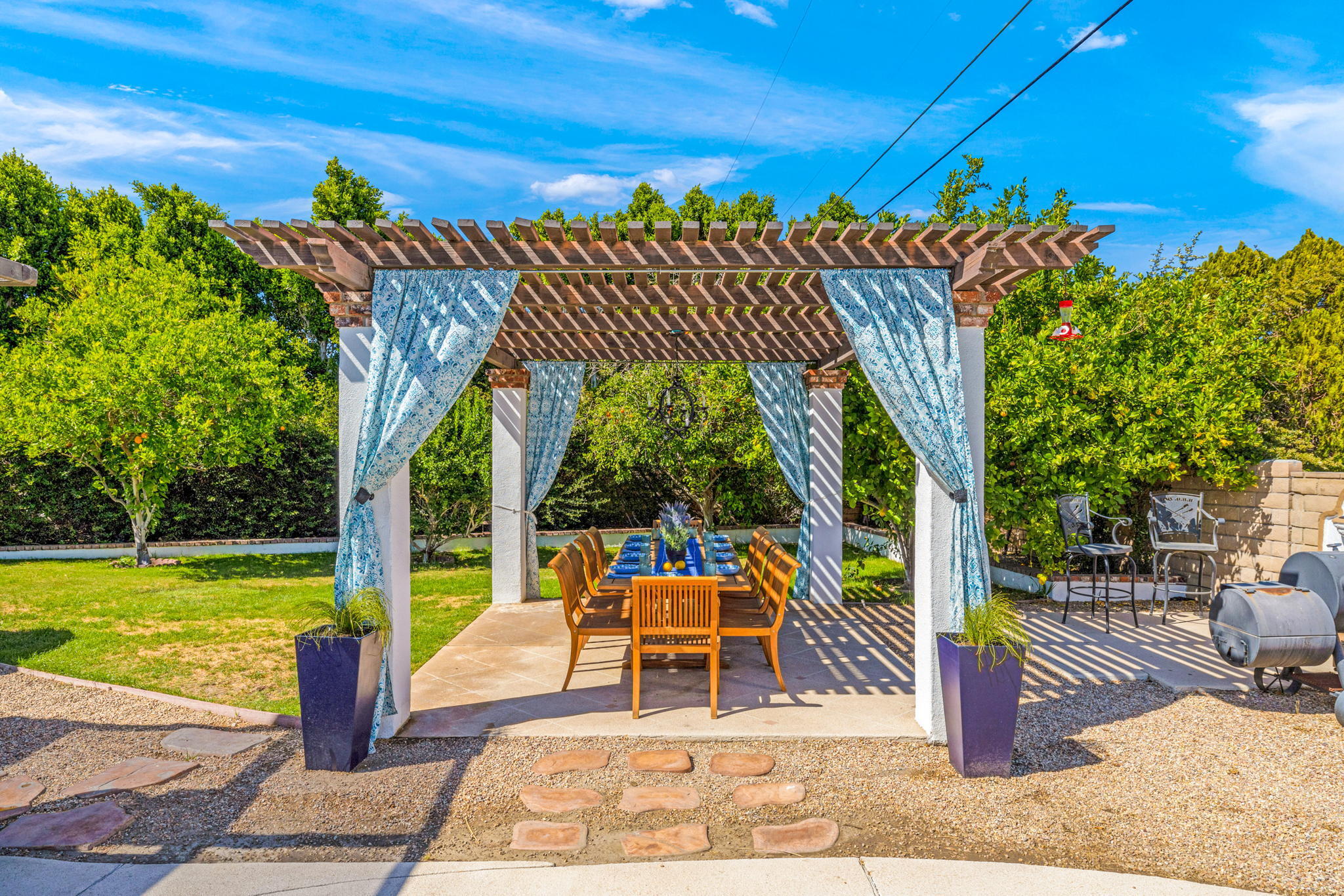 2290 North Victoria Road Palm Springs, CA 92262 - Photo 5 of 42 a view of a patio with a table and chairs next to a yard