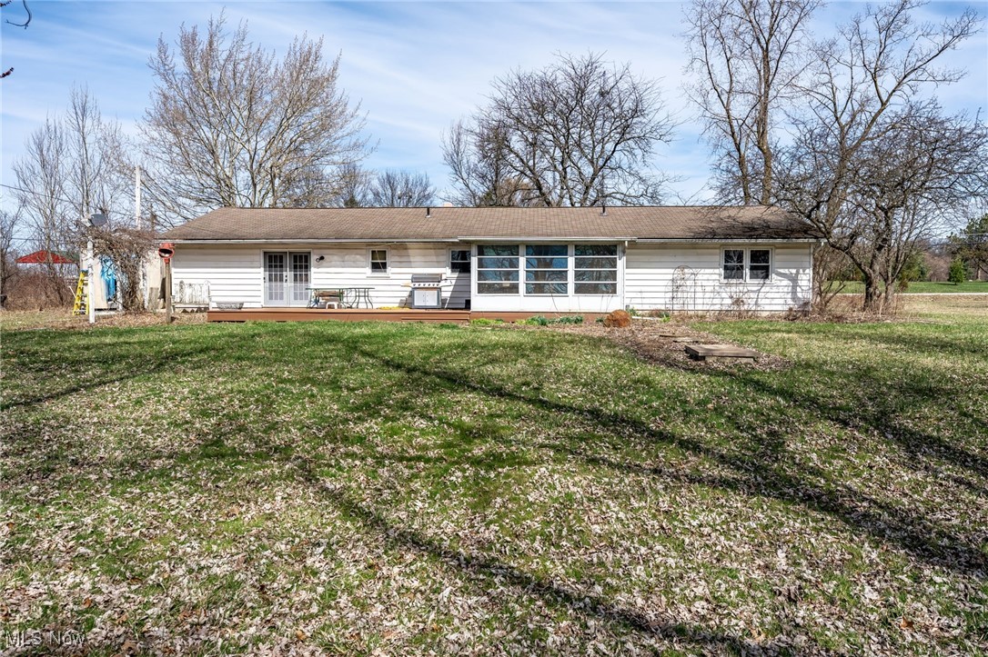 4790 Paradise Road Seville, OH 44273 - Photo 8 of 45 Rear view of house featuring a lawn, a wooden deck, and french doors