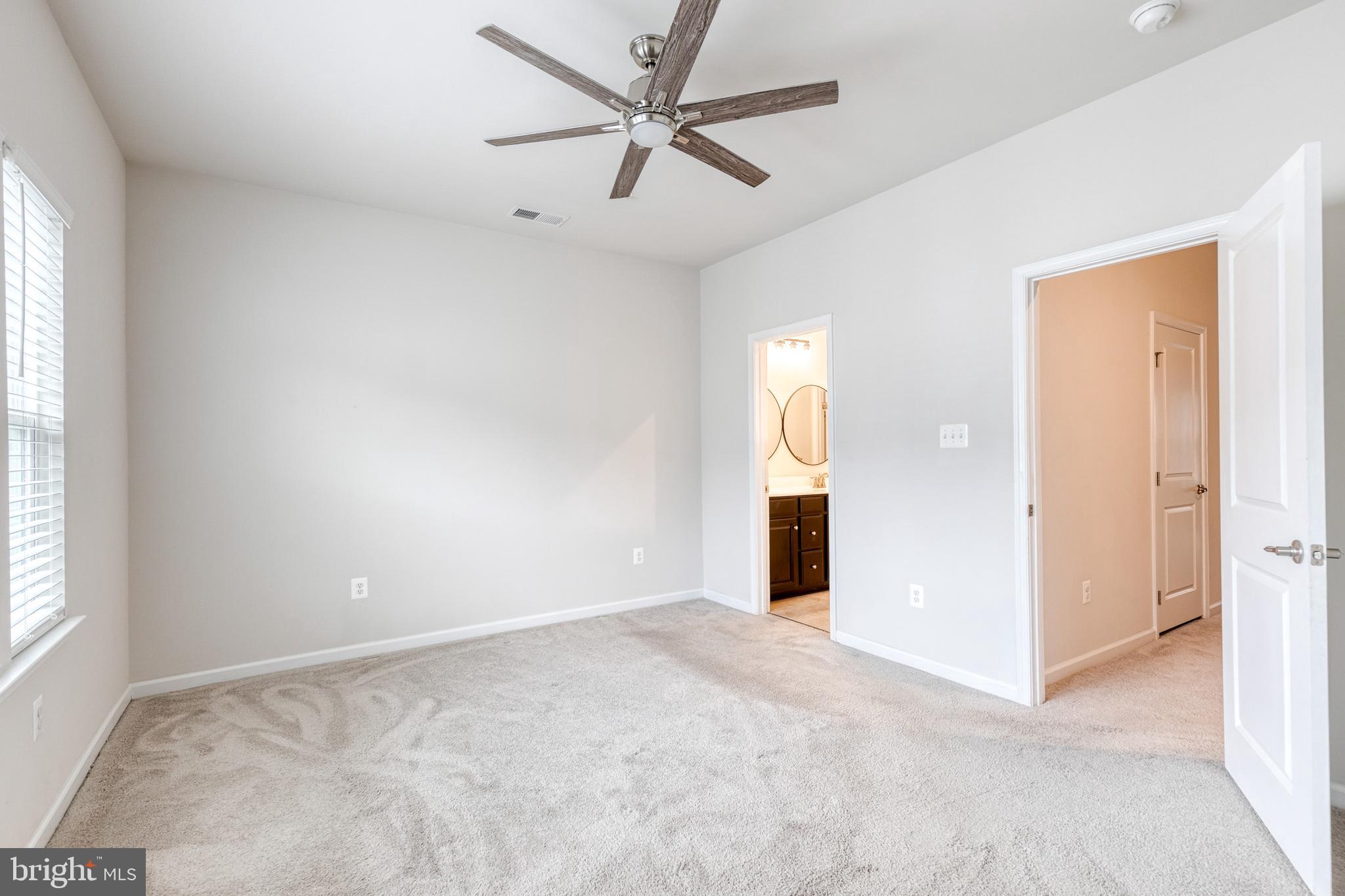 1438 Strahorn Road Hanover, MD 21076 - Photo 11 of 19 an empty room with windows and fan