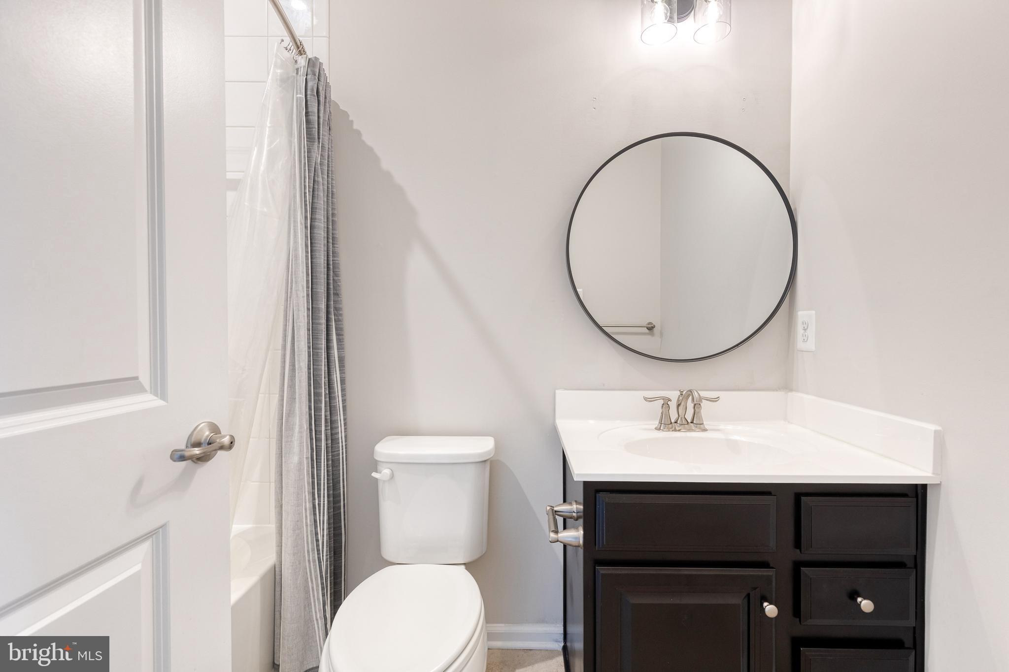 1438 Strahorn Road Hanover, MD 21076 - Photo 15 of 19 a bathroom with a sink a toilet and a mirror