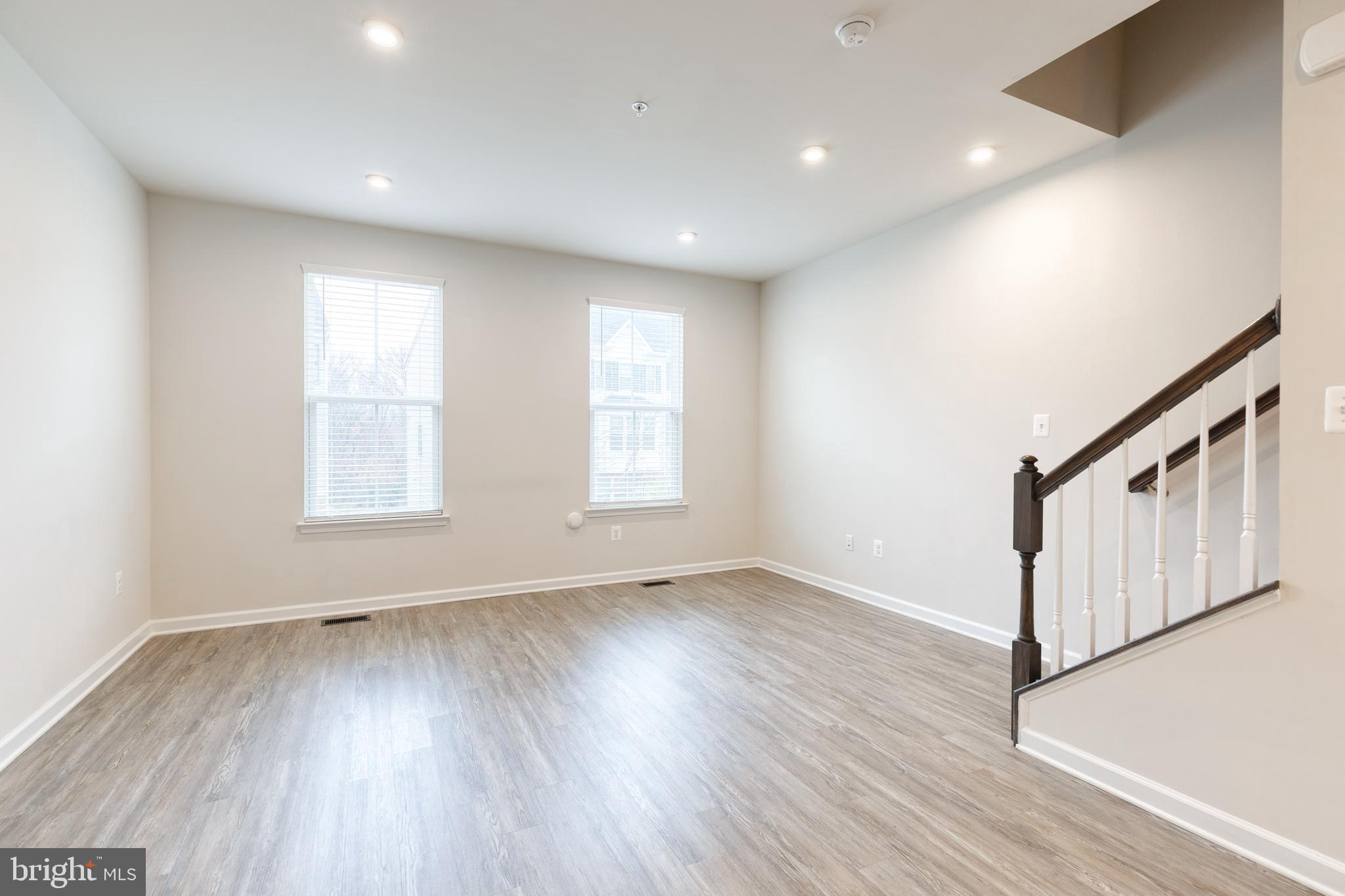 1438 Strahorn Road Hanover, MD 21076 - Photo 3 of 19 a view of an empty room with wooden floor and a window