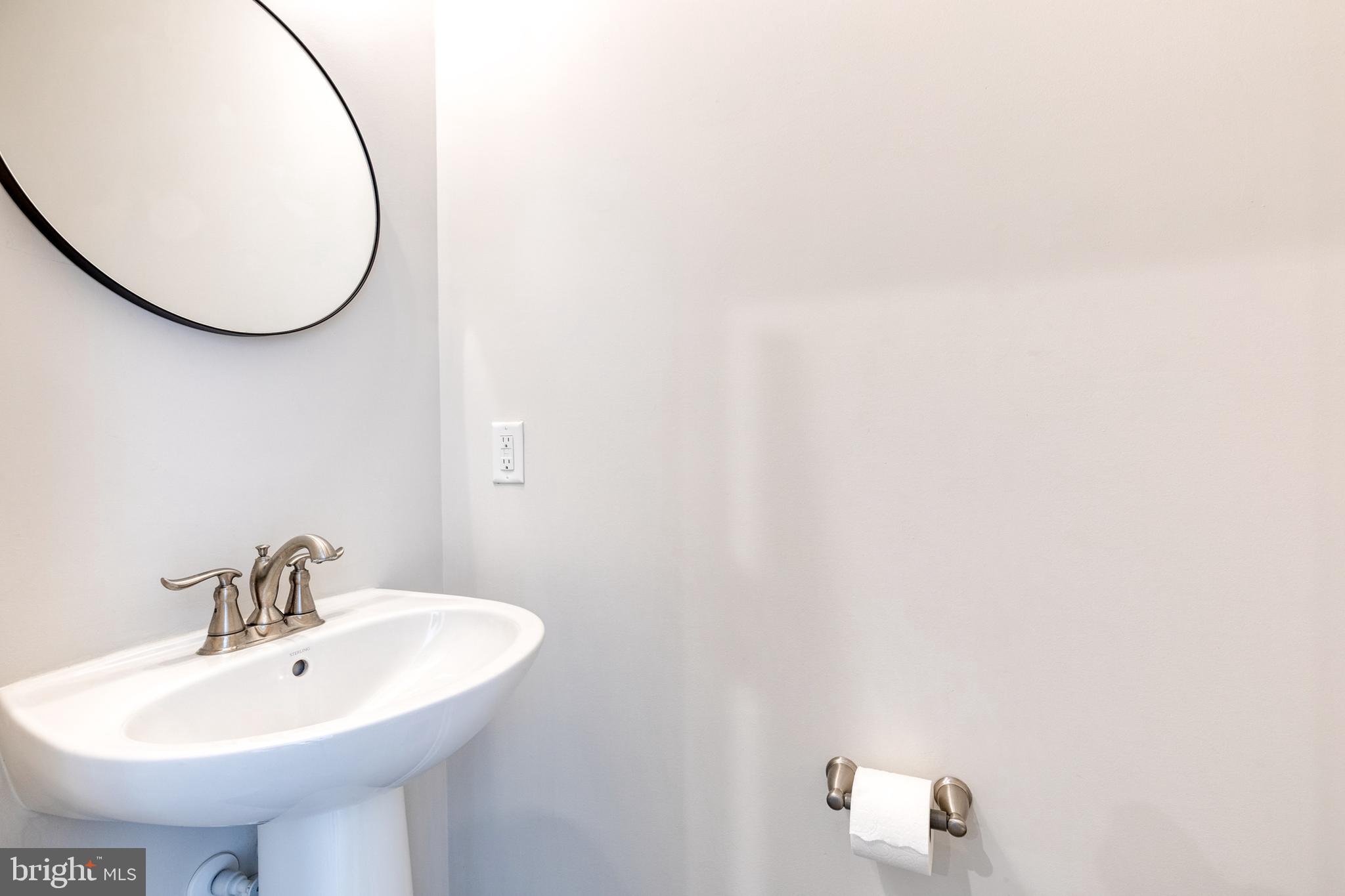 1438 Strahorn Road Hanover, MD 21076 - Photo 9 of 19 a bathroom with a sink and a mirror