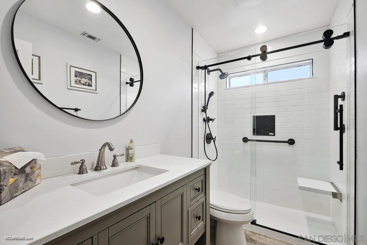 9541 Mandeville Road Santee, CA 92071 - Photo 20 of 32 a bathroom with a sink a toilet and a mirror
