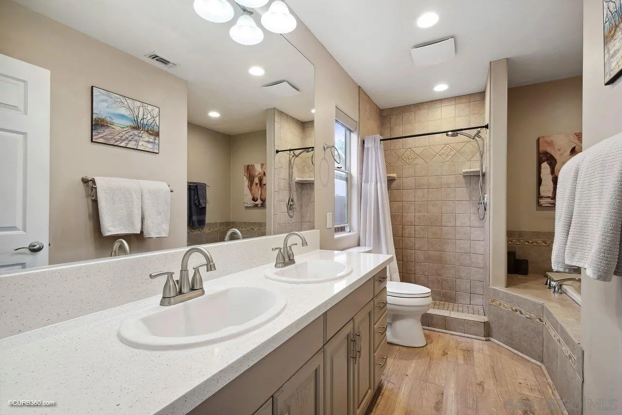 9541 Mandeville Road Santee, CA 92071 - Photo 23 of 32 a bathroom with a double vanity sink toilet and shower