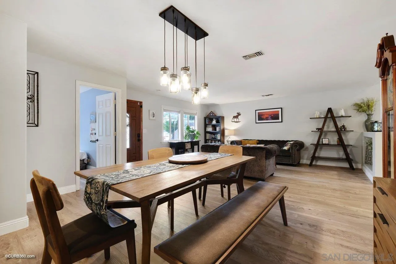 9541 Mandeville Road Santee, CA 92071 - Photo 8 of 32 a view of a dining room with furniture and wooden floor