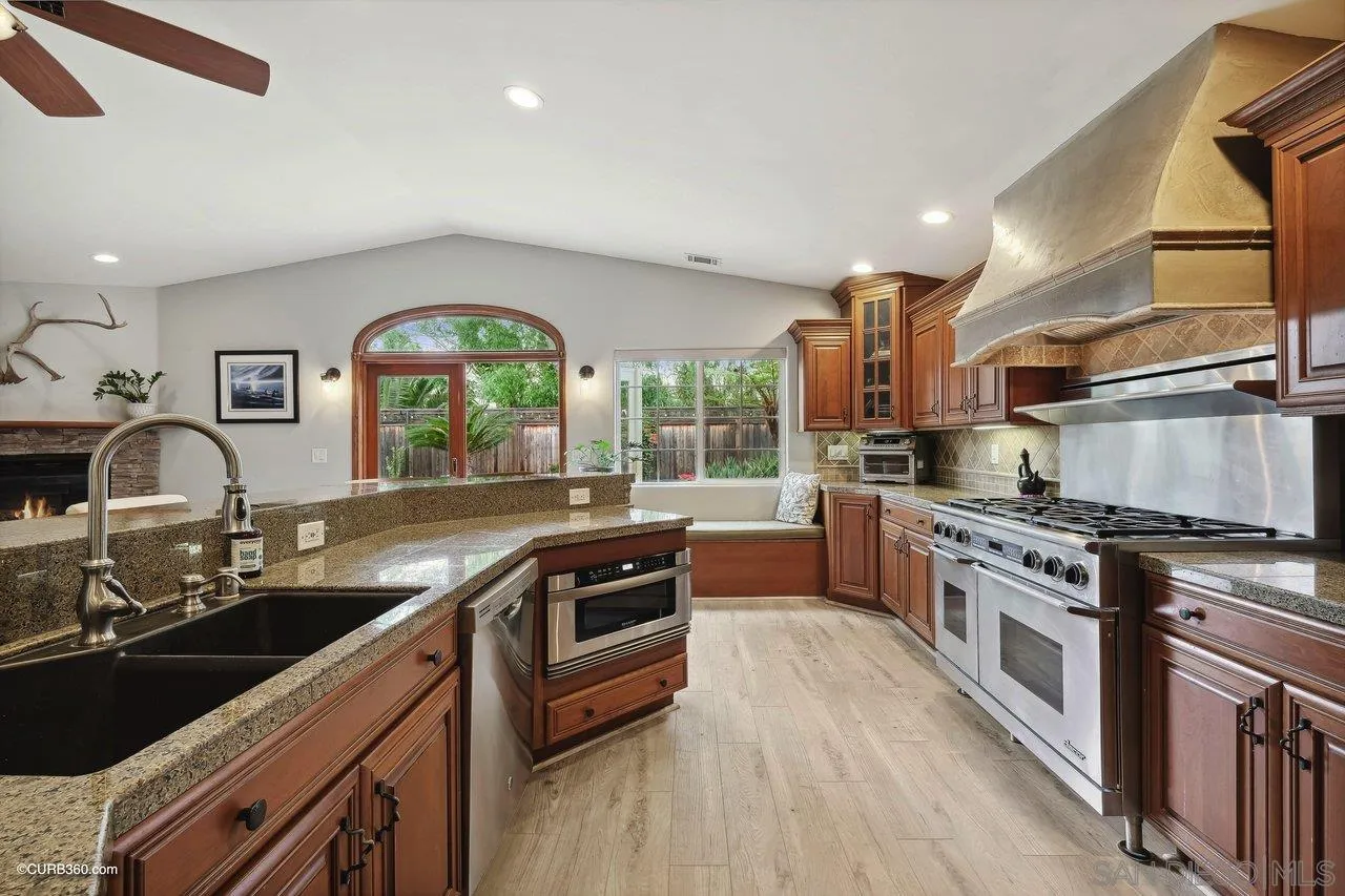 9541 Mandeville Road Santee, CA 92071 - Photo 10 of 32 a kitchen with stainless steel appliances granite countertop a stove a sink and a microwave