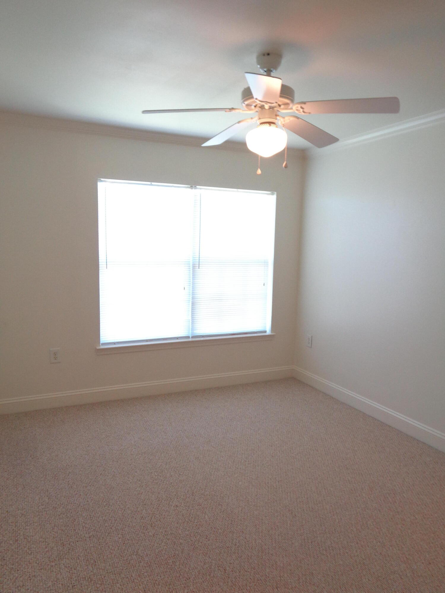 555 Wingspan Way Crestview, FL 32536 - Photo 20 of 24 en empty room with window and chandelier fan