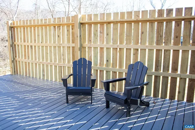 a view of a wooden chairs on the deck