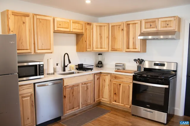 a kitchen with cabinets appliances and a sink
