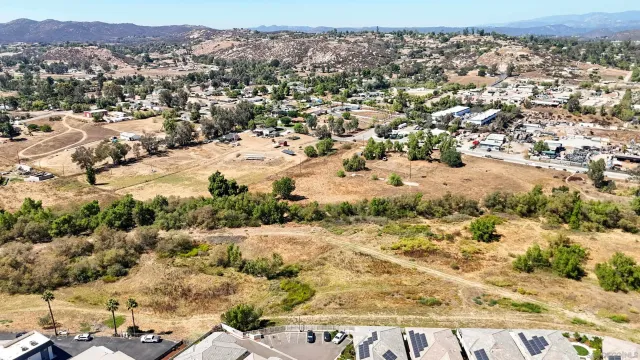 an aerial view of residential house and sandy dunes