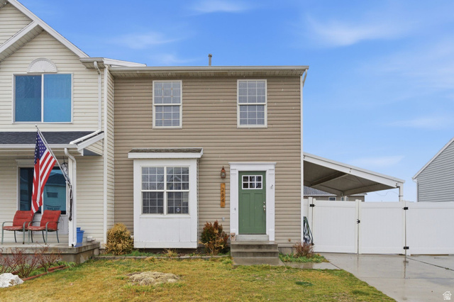 284 Alfred Drive Tooele, UT 84074 - Photo 1 of 1 Traditional-style home featuring a gate, entry steps, a front yard, and an attached carport