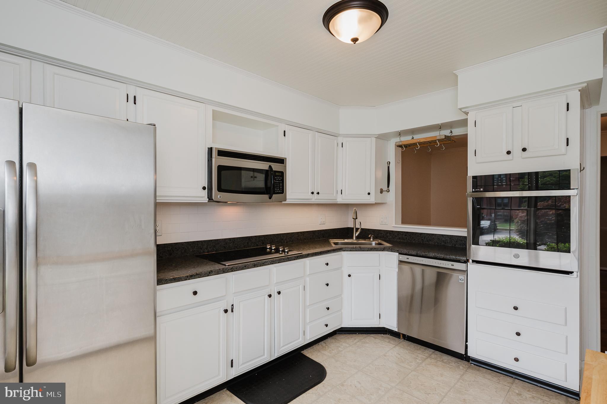 27 Faraday Drive Lutherville-Timonium, MD 21093 - Photo 11 of 60 a kitchen with granite countertop white cabinets white stainless steel appliances and a sink