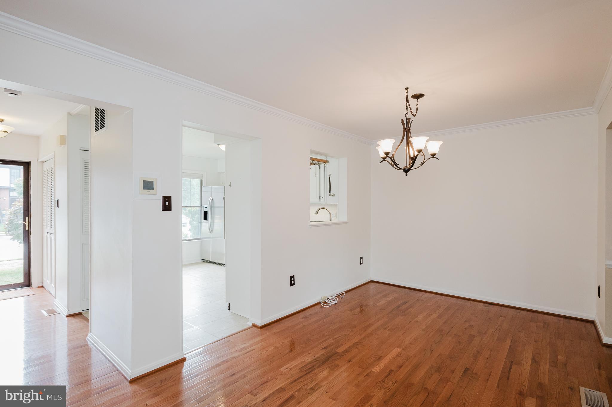 27 Faraday Drive Lutherville-Timonium, MD 21093 - Photo 17 of 60 a view of empty room with wooden floor and kitchen