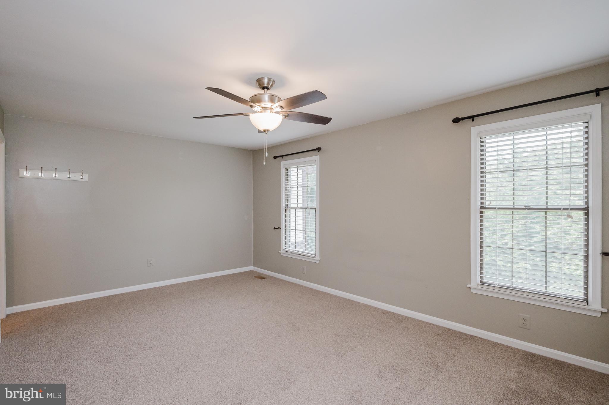 27 Faraday Drive Lutherville-Timonium, MD 21093 - Photo 24 of 60 an empty room with windows and ceiling fan
