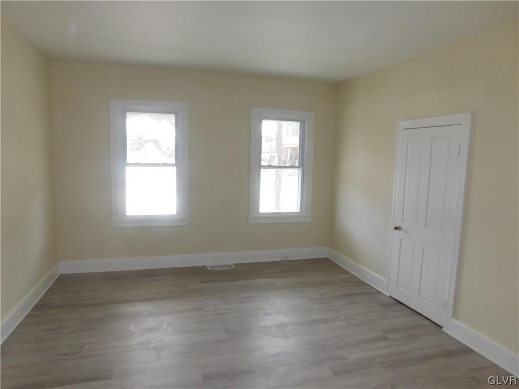 121 Main Street Stockertown, PA 18083 - Photo 11 of 28 an empty room with wooden floor and windows