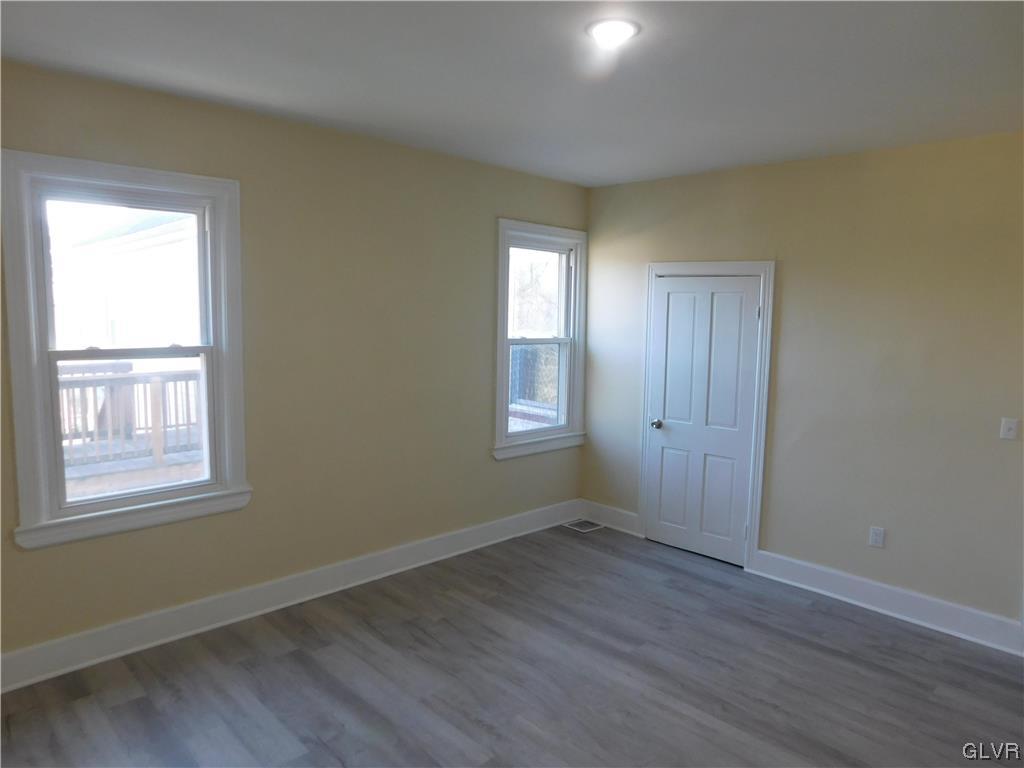 121 Main Street Stockertown, PA 18083 - Photo 16 of 28 an empty room with wooden floor and windows