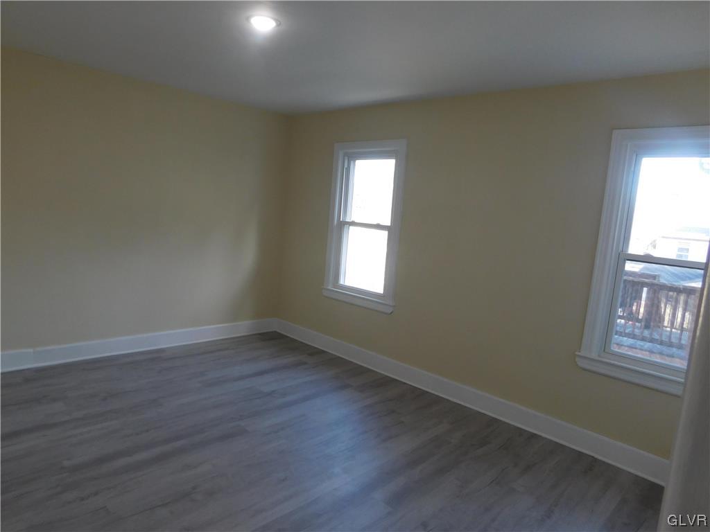 121 Main Street Stockertown, PA 18083 - Photo 17 of 28 an empty room with wooden floor and windows
