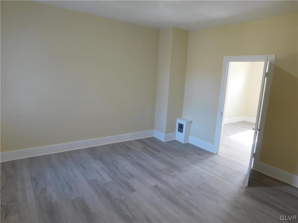121 Main Street Stockertown, PA 18083 - Photo 19 of 28 a view of an empty room with wooden floor and a window