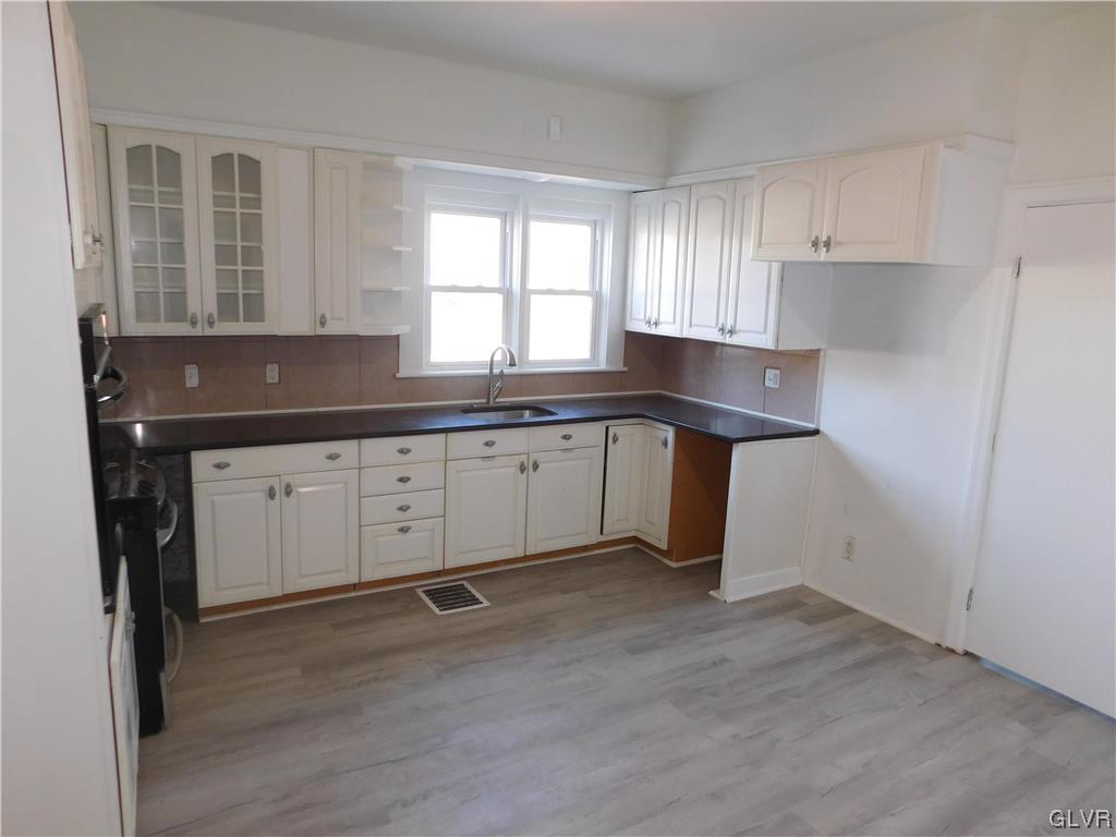 121 Main Street Stockertown, PA 18083 - Photo 6 of 28 a kitchen with sink cabinets and wooden floor