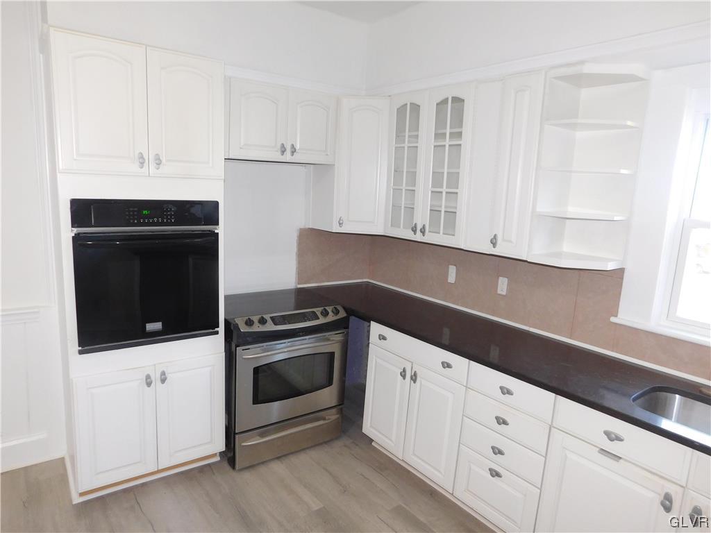 121 Main Street Stockertown, PA 18083 - Photo 7 of 28 a kitchen with granite countertop white cabinets stainless steel appliances and sink