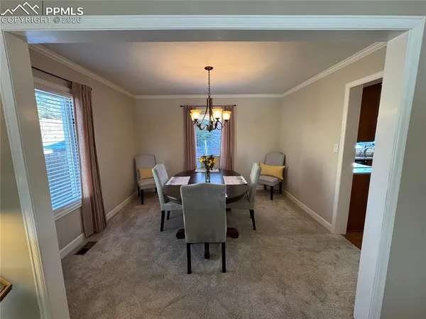 a view of a livingroom with furniture and a potted plant