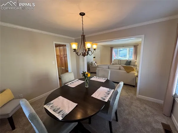 a kitchen with sink and view of living room